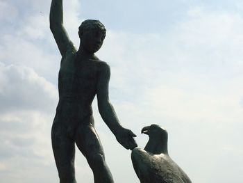 Low angle view of statue against cloudy sky