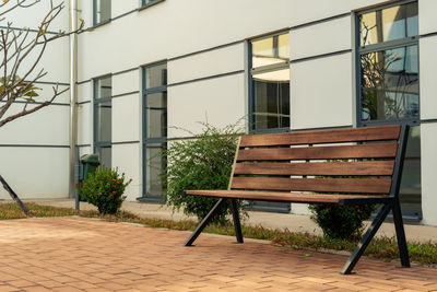 Empty chairs and table against building in city