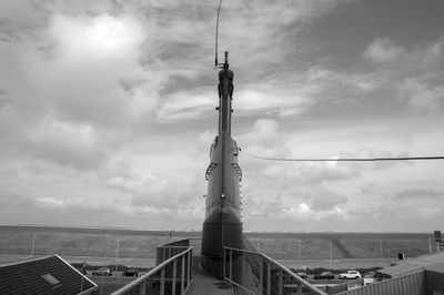 Low angle view of railing by sea against sky