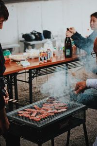 People standing on barbecue grill