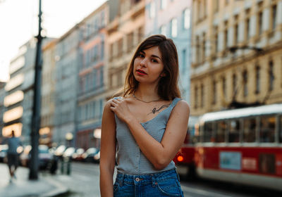 Portrait of beautiful woman standing in city