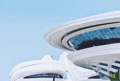 Low angle view of modern building against blue sky