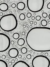 Directly below shot of raindrops on glass window