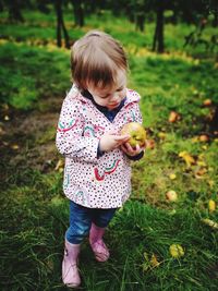 Toddler in apple orchard