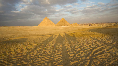 Camels long shadow over giza pyramidsview in cairo egypt landmark