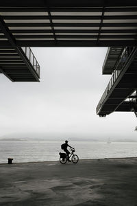 Silhouette of a man riding a bike