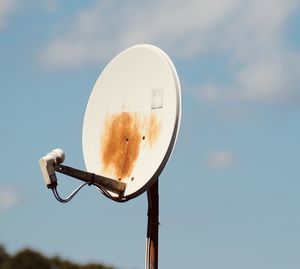 Low angle view of security camera against sky