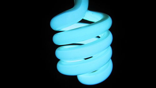 Close-up of light bulb against black background