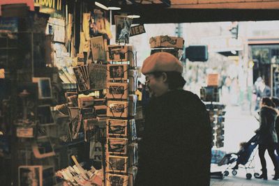 Rear view of man standing at store