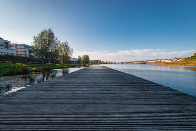 View of wooden pier in phoenixsee lake against sky