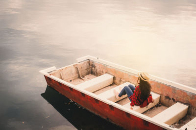 High angle view of people on boat moored in lake