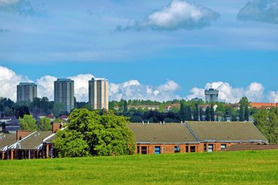 View of buildings in city against sky from tollcross park vantage point. 