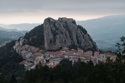 Townscape by mountain against sky