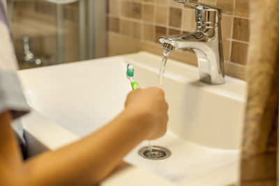 Midsection of woman in bathroom at home