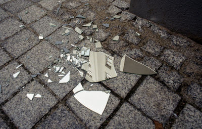 High angle view of broken glass on street