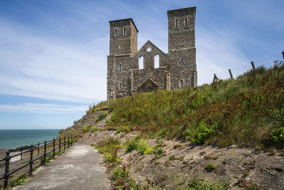 Built structure on sea shore against sky