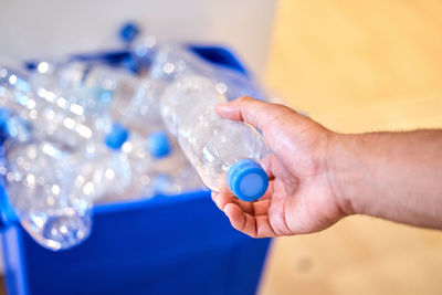 Cropped hand holding bottle