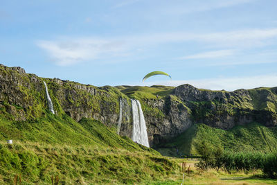 Low angle view of waterfall against sky