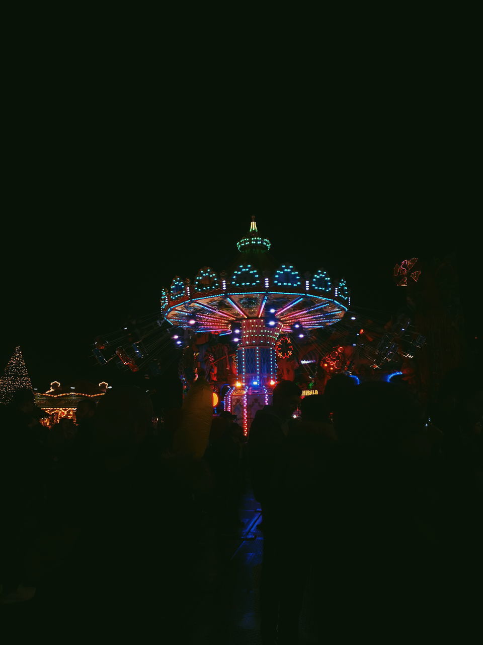 ILLUMINATED CAROUSEL AT NIGHT