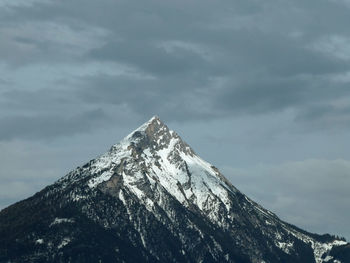 Low angle view of snowcapped mountain against sky