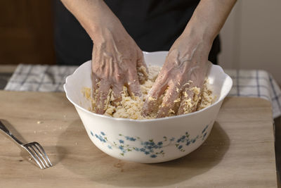 Midsection of person preparing food on table