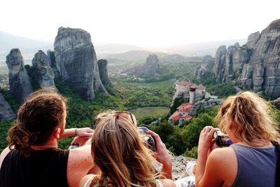 Rear view of women walking on mountain