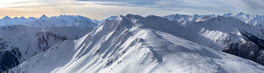 Panoramic view of snowcapped mountains against sky