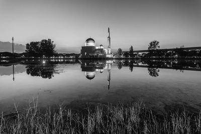 Scenic view of lake against clear sky at night