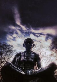 Low angle view of statue against cloudy sky