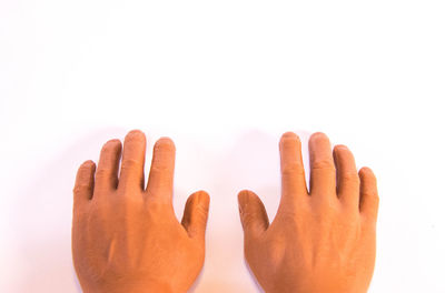 Close-up of hand against white background