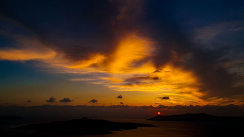 Scenic view of silhouette mountains against sky at sunset