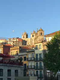 Low angle view of buildings against clear blue sky
