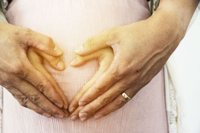 Close-up of hands holding heart shape