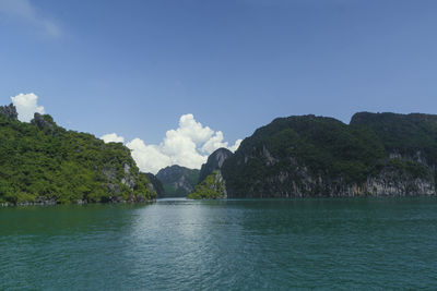 Scenic view of sea and mountains against sky