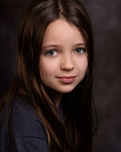 Close-up portrait of cute smiling girl at home