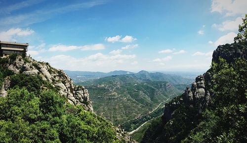 Scenic view of mountains against cloudy sky