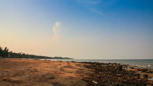 Scenic view of beach against sky during sunset