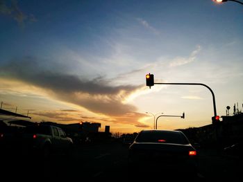 Cars on road at sunset