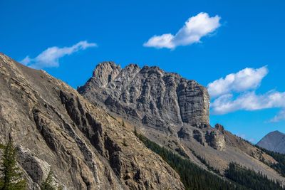 Low angle view of mountains against blue sky