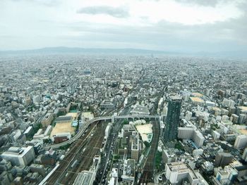 High angle view of city street by buildings against sky