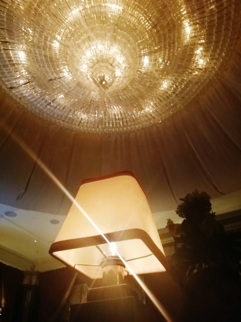 indoors, ceiling, illuminated, lighting equipment, low angle view, hanging, glowing, chandelier, decoration, electric light, electricity, light - natural phenomenon, pattern, no people, design, electric lamp, luxury, glass - material, built structure, light