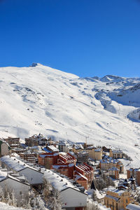 High angle view of townscape against blue sky during winter