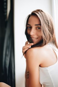 Portrait of smiling young woman at home