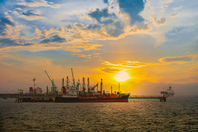 Commercial dock against sky during sunset