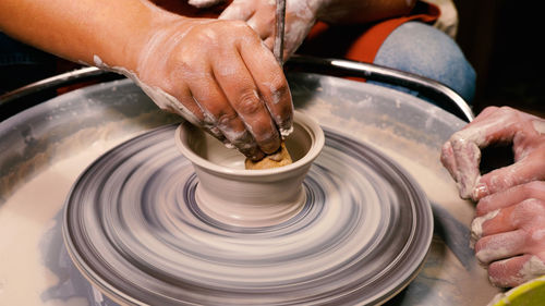 Close-up of man making pottery at workshop