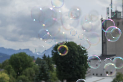 Close-up of bubbles against rainbow in sky