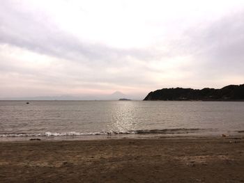 Scenic view of sea against cloudy sky