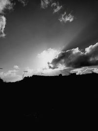 Low angle view of silhouette landscape against sky
