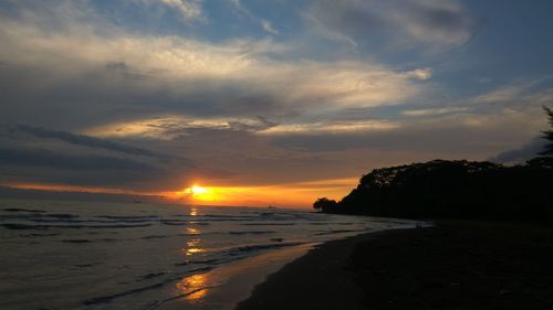 Scenic view of beach against sky during sunset