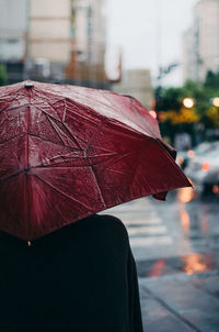 Person on wet street in city during rainy season